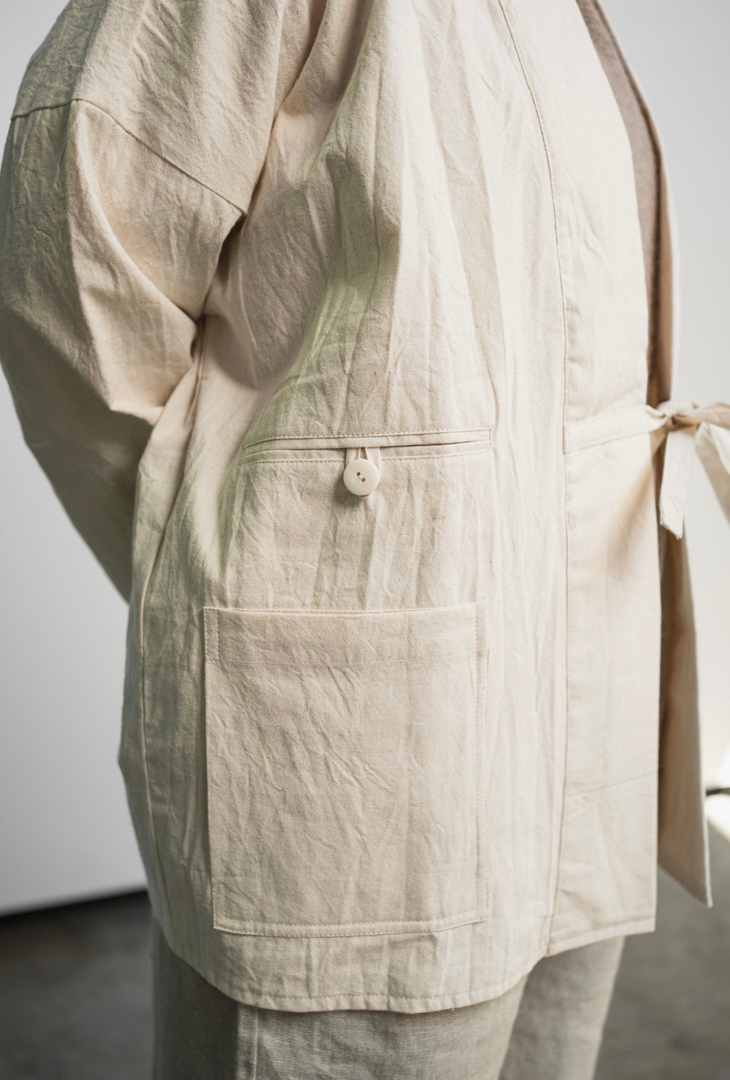 Unisex cotton canvas blazer jacket in undyed, unbleached fabric with three pockets and minimalist design