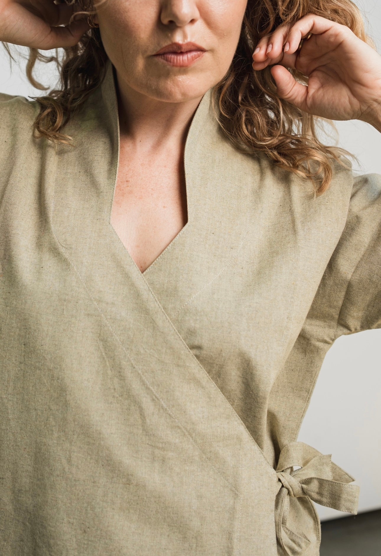 Japanese-inspired wrap garment with V-neck design and adjustable layered fit
