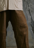 Lightweight linen trousers with elastic waistband, abstract hem detail, and unisex fit

