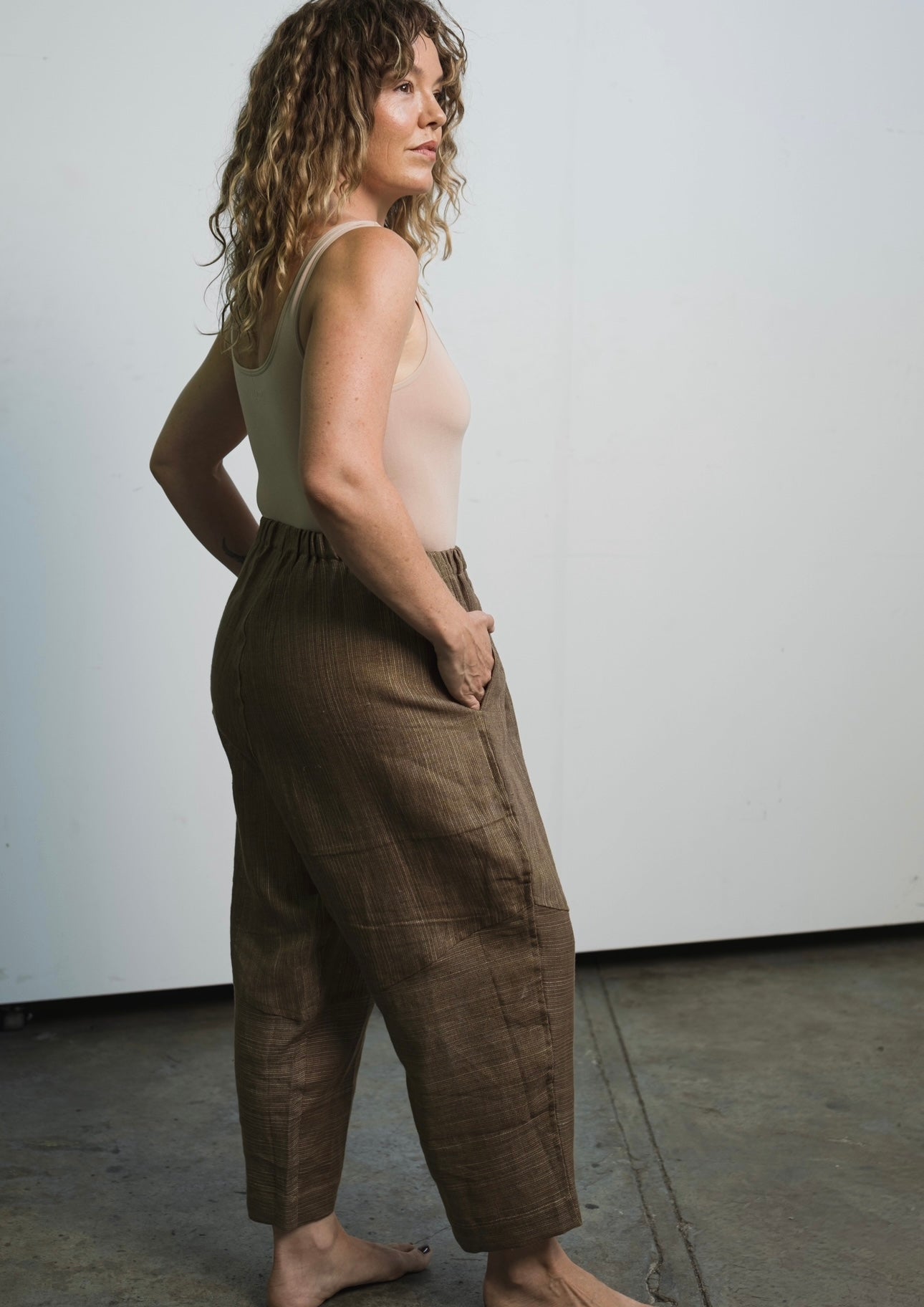 Lightweight linen trousers with elastic waistband, abstract hem detail, and unisex fit
