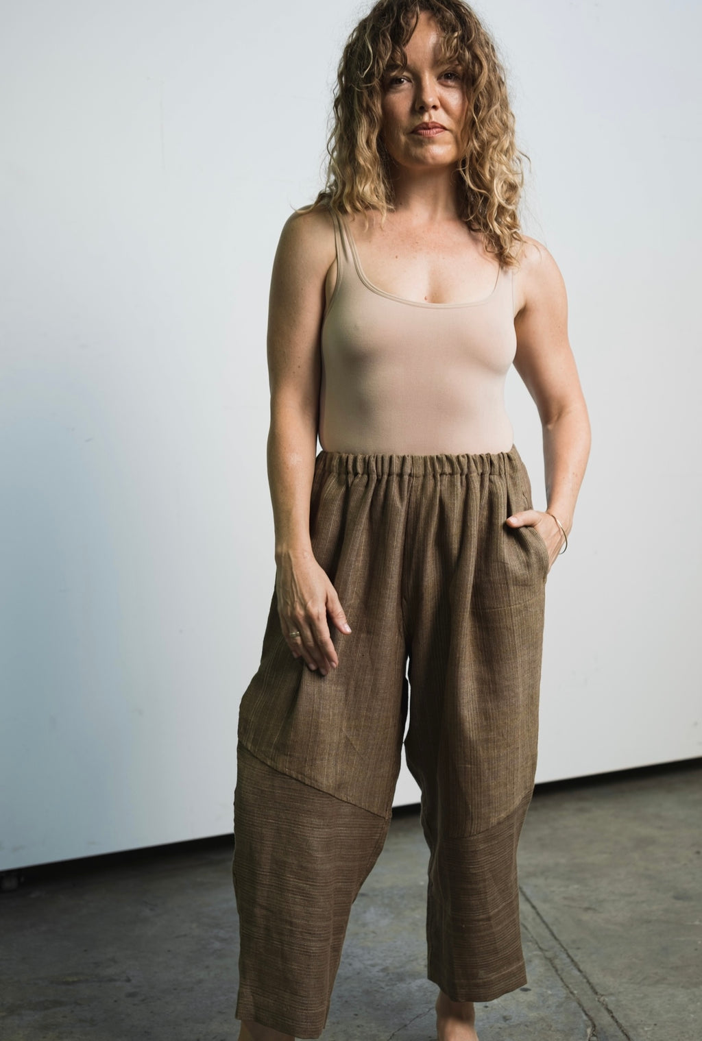 Lightweight linen trousers with elastic waistband, abstract hem detail, and unisex fit
